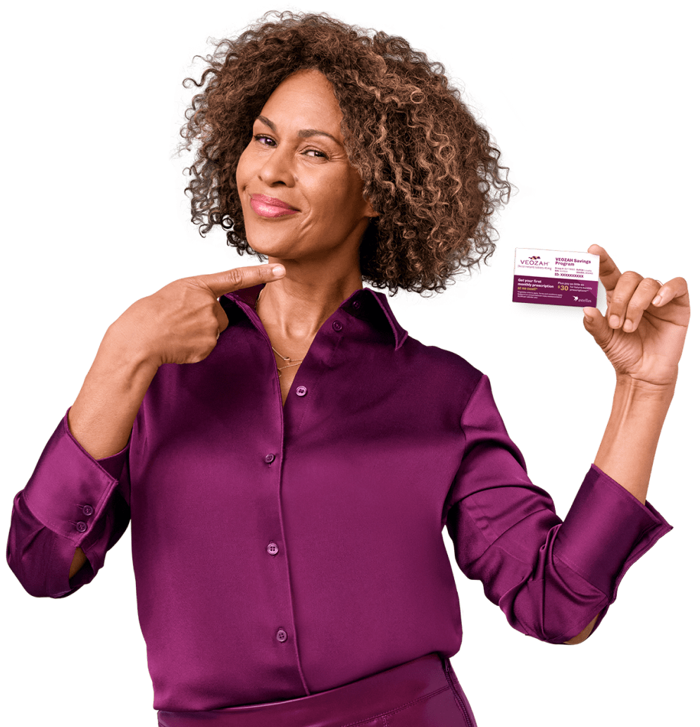 A lady holding a VEOZAH savings card