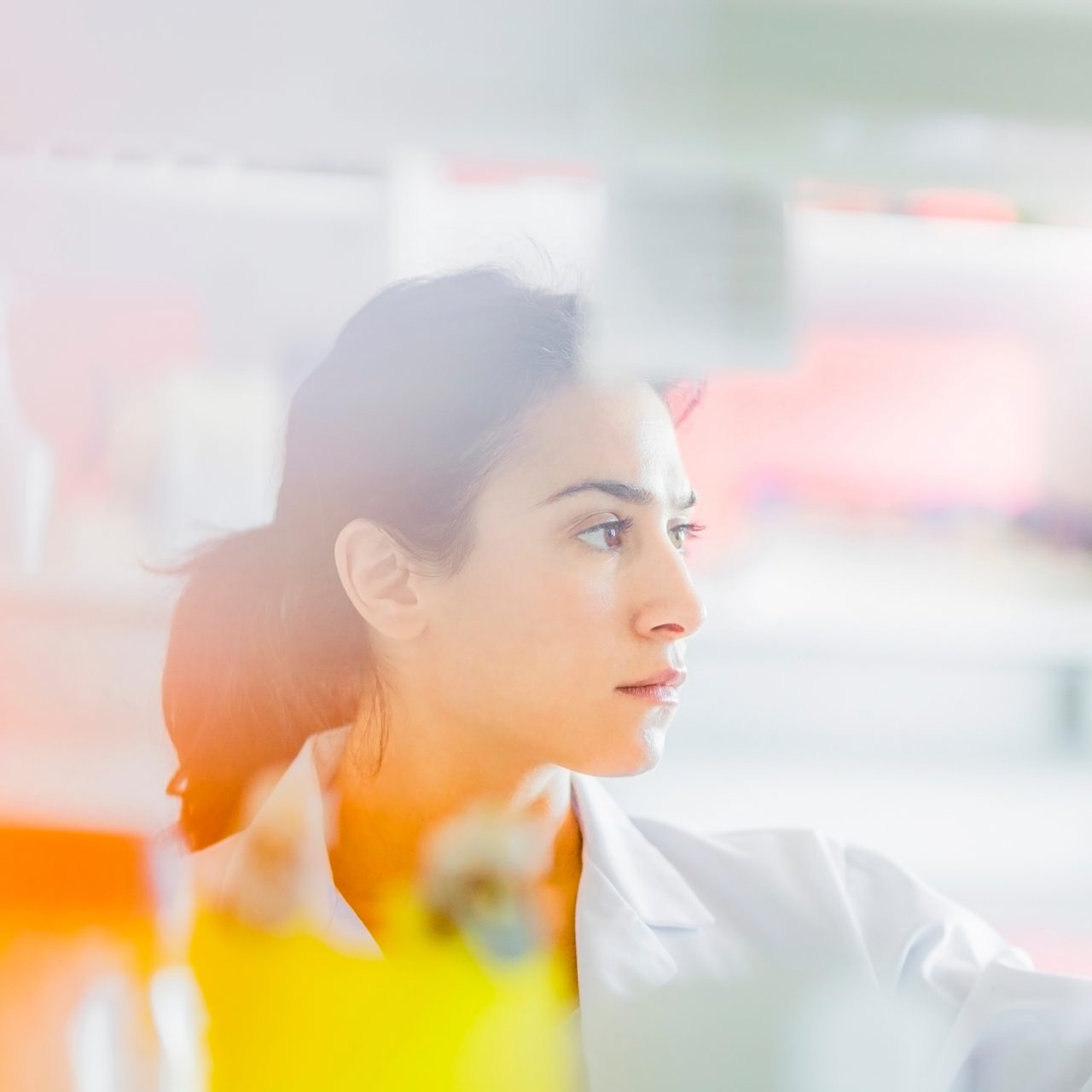 An Astellas researcher examines a vial in the lab, reflecting our focus on research and development to drive long-term market value.