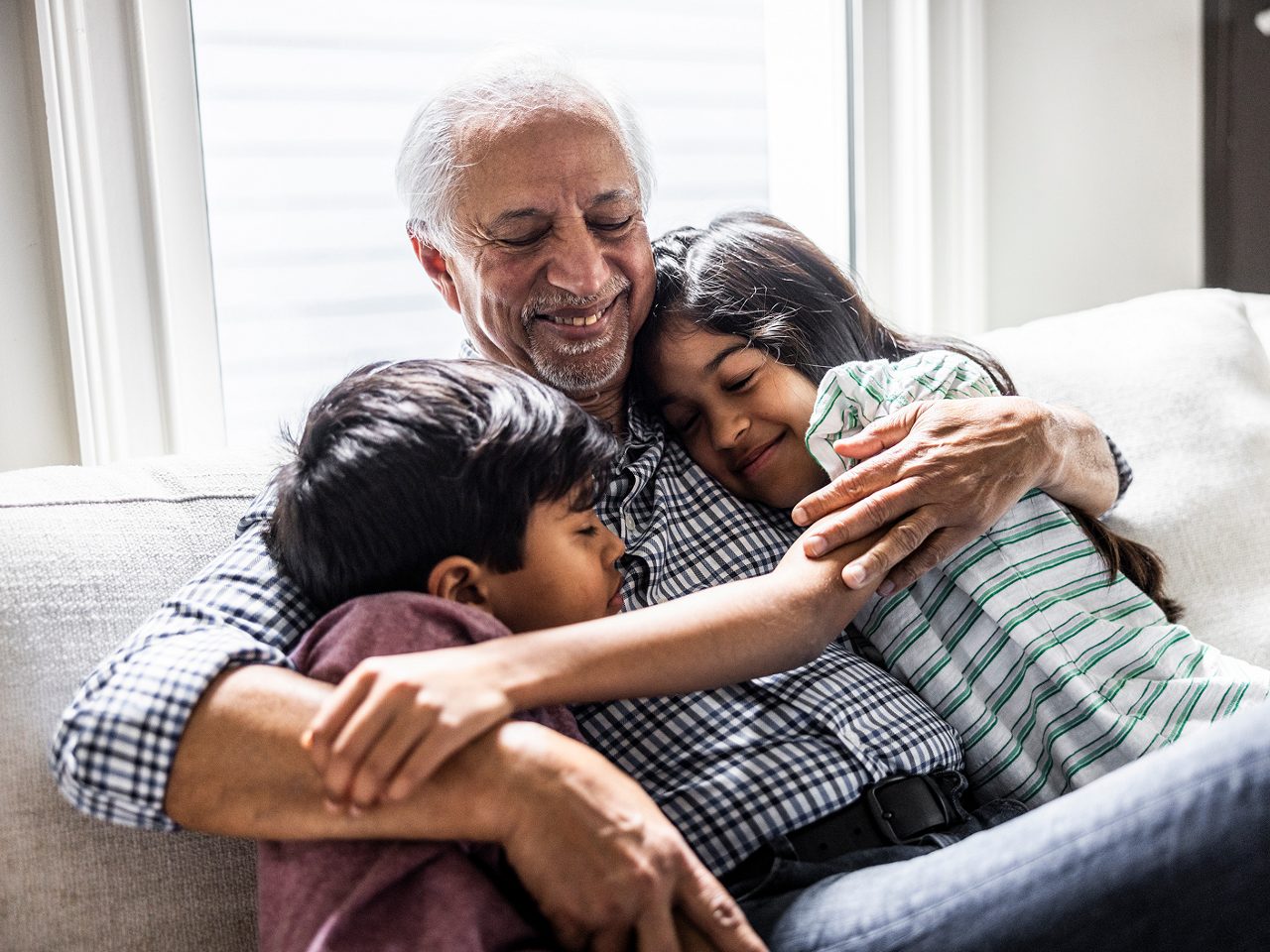A grandparent holding grandchildren, expressing Astellas’ commitment to patient-centric care.