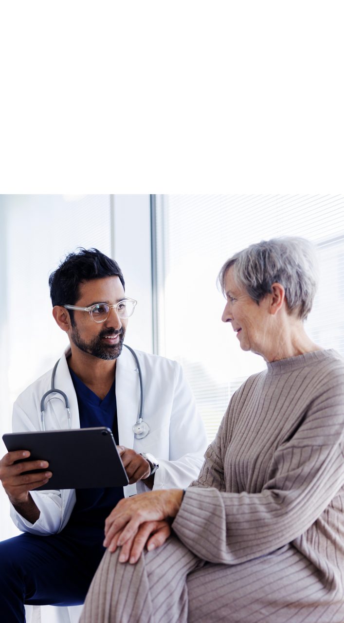 A doctor speaks with an older patient, illustrating how Access to Health is essential to the health of people around the world.