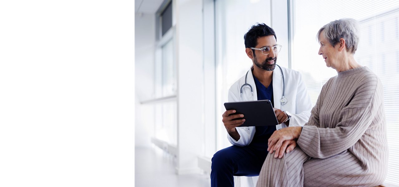 A doctor speaks with an older patient, illustrating how Access to Health is essential to the health of people around the world.