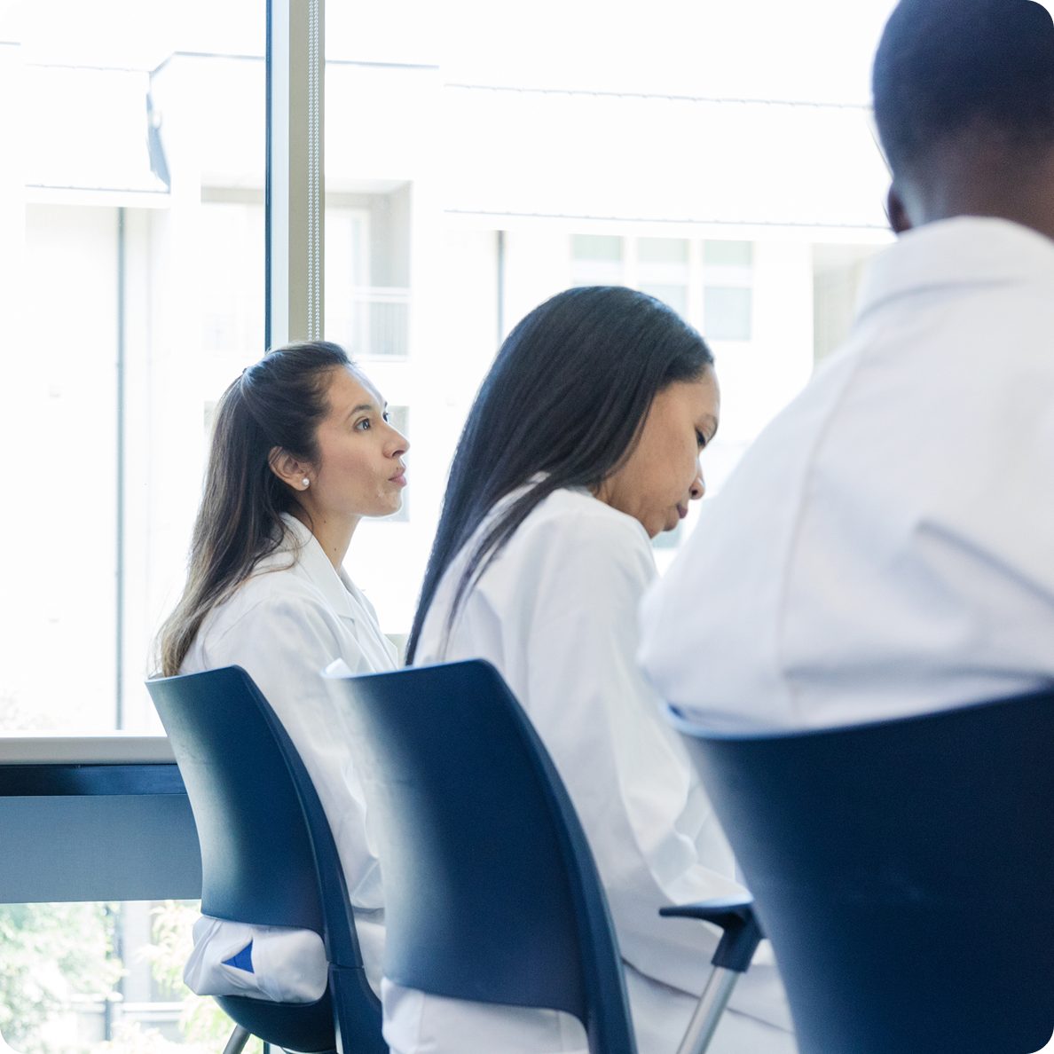 Astellas scientists gather at a meeting as part of a culture that values bold ideas and collaborative innovation.