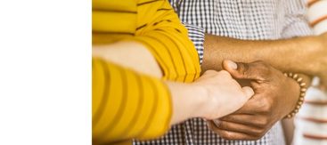 A family embraces hands, illustrating Astellas’ focus on providing patients with access to healthcare.