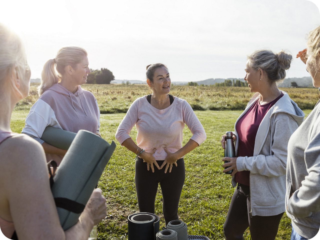 Image of a group of five women outdoors talking about kegel exercise