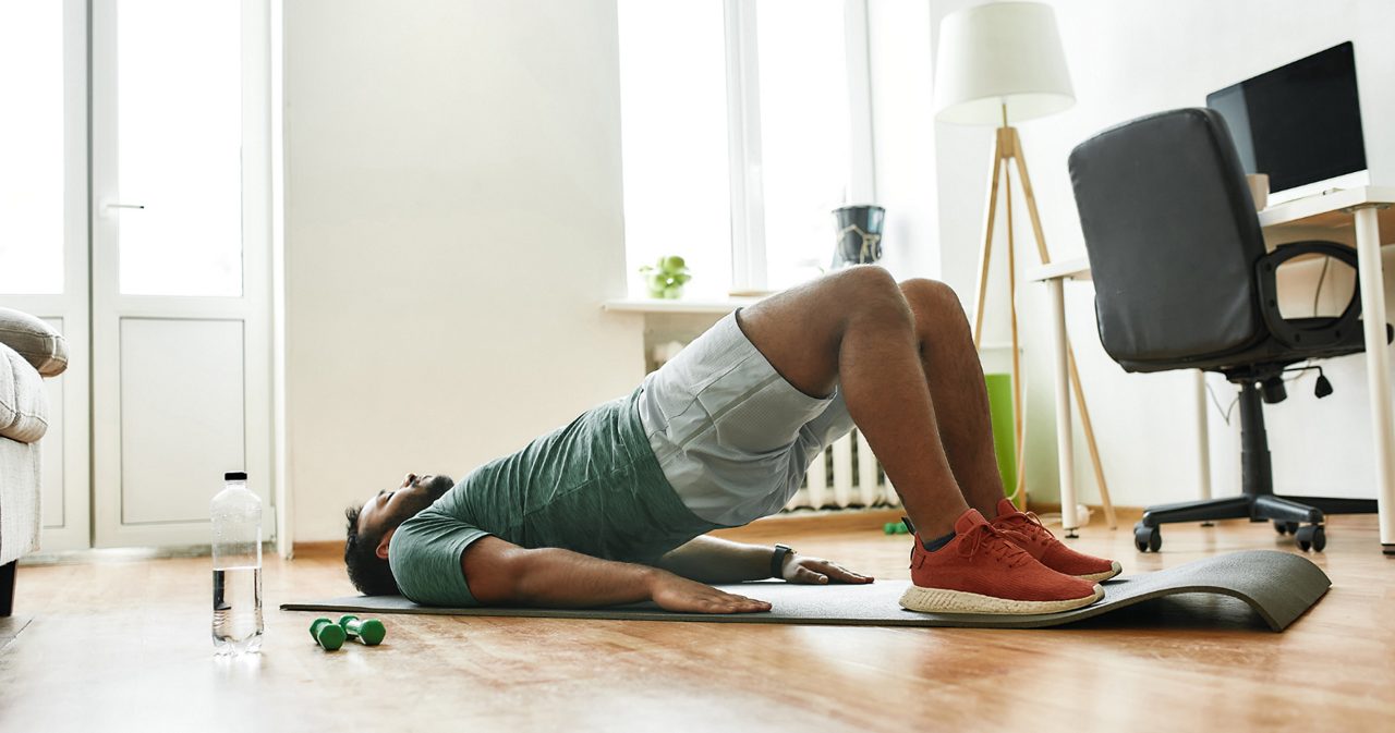 Image of a man doing floor exercises on a mat