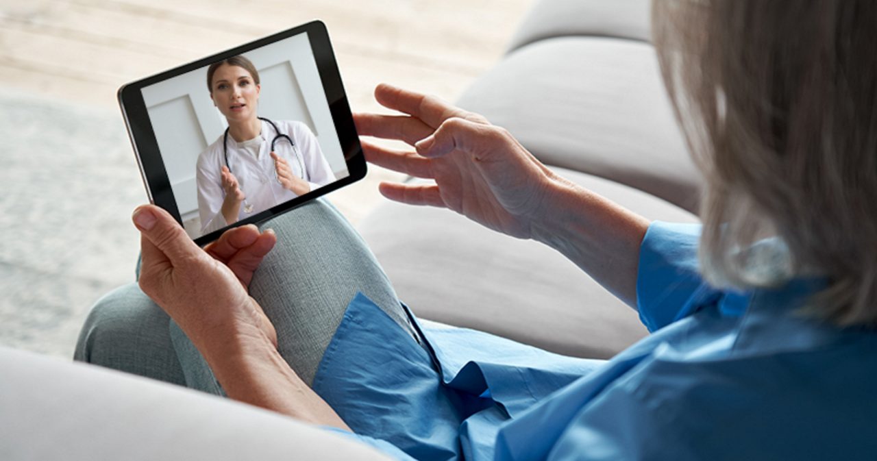 Image of a woman talking with a doctor via video call on a tablet