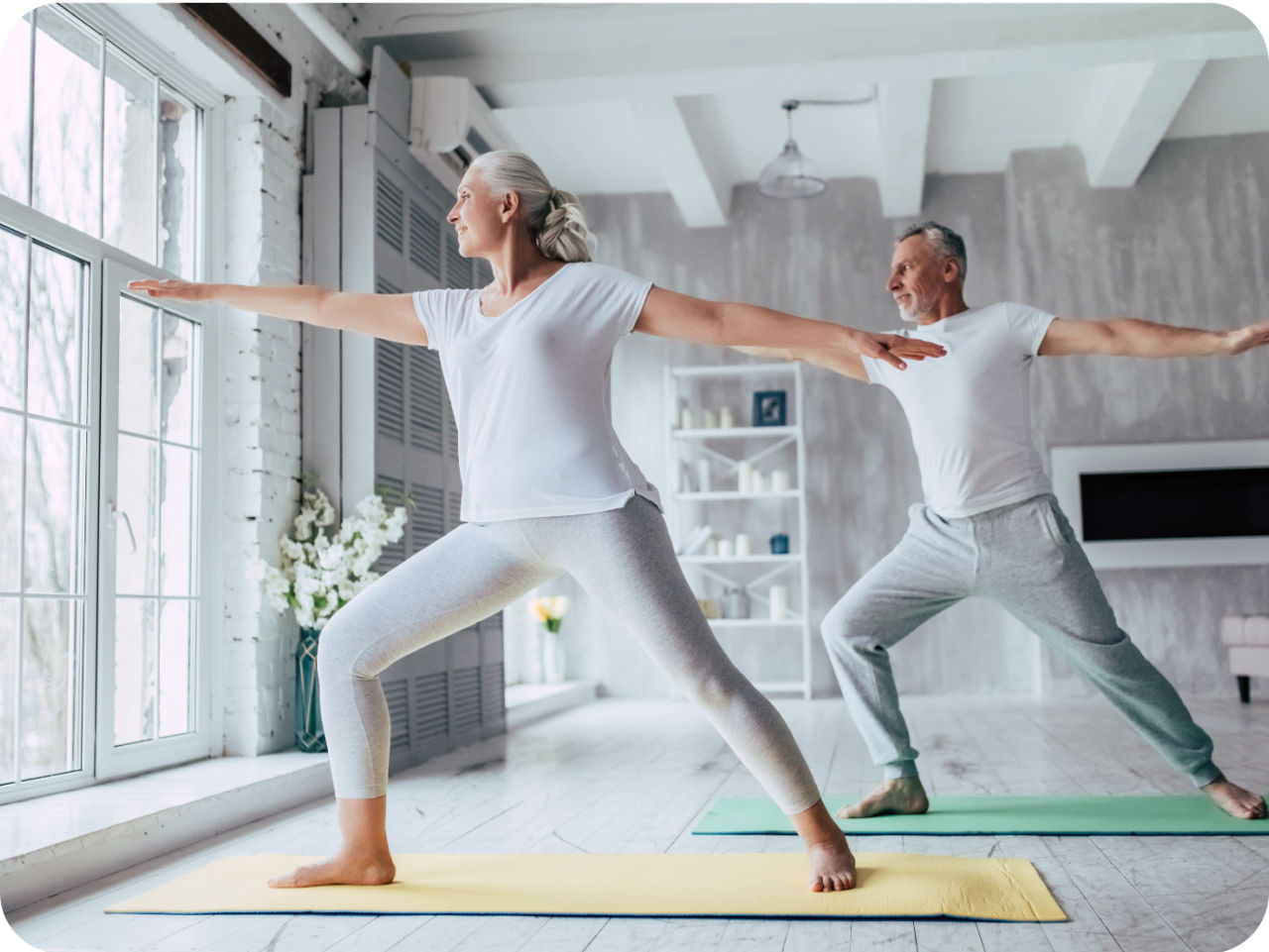 Image of a woman and a man stretching. They are using white clothes