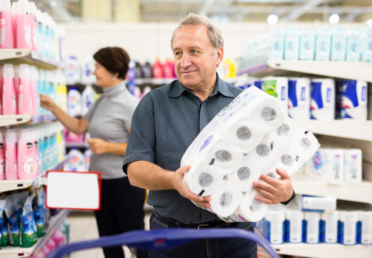 Mature man choosing packaged piece of meat