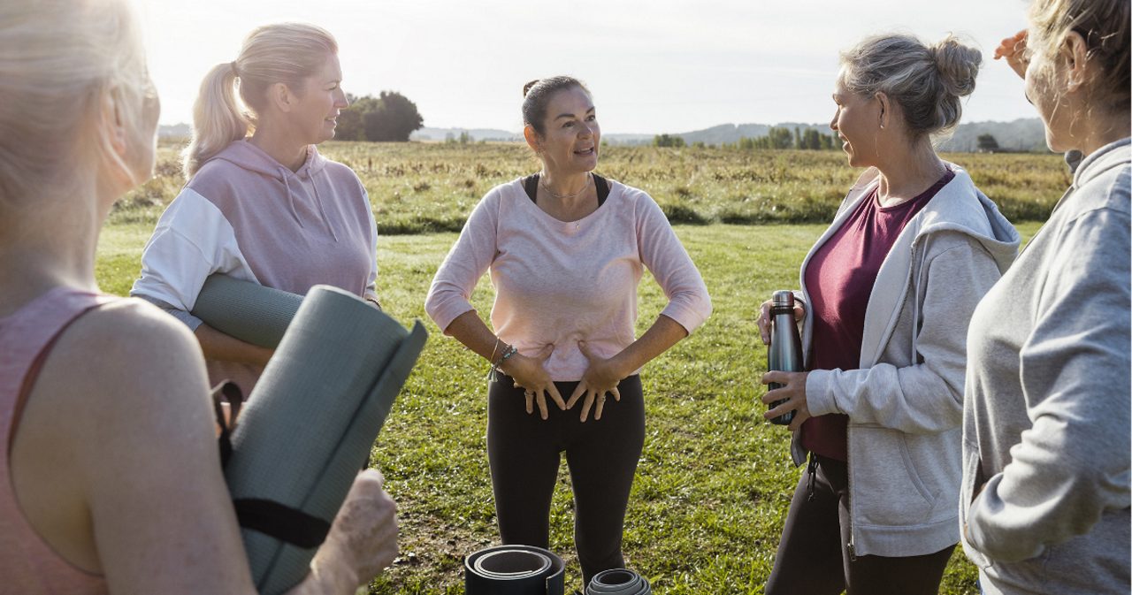 Image of a group of five women outdoors talking about kegel exercise